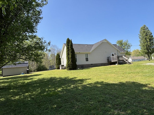 view of home's exterior featuring crawl space, a deck, and a lawn