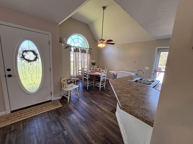 entryway with dark wood-type flooring, baseboards, a ceiling fan, and lofted ceiling