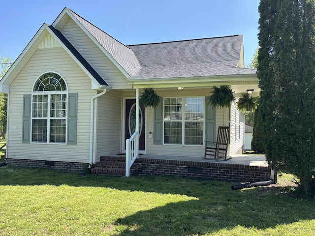 view of front facade with roof with shingles, crawl space, and a front lawn
