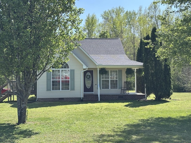 view of front of property featuring a front yard, a shingled roof, covered porch, and crawl space
