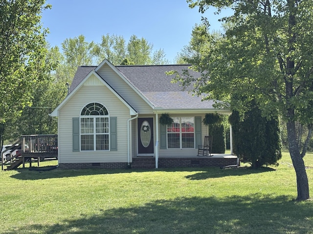 view of front of property with crawl space, roof with shingles, a front yard, and a deck