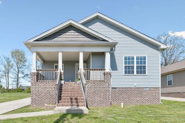 bungalow-style home with a front yard, a porch, and stairway