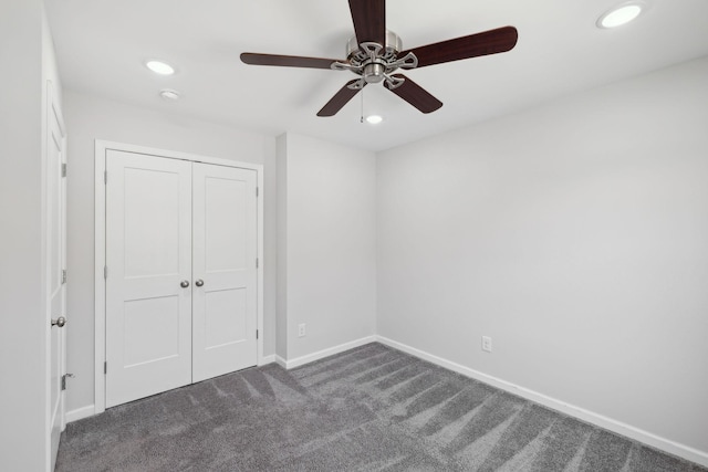 unfurnished bedroom with ceiling fan, a closet, recessed lighting, dark colored carpet, and baseboards