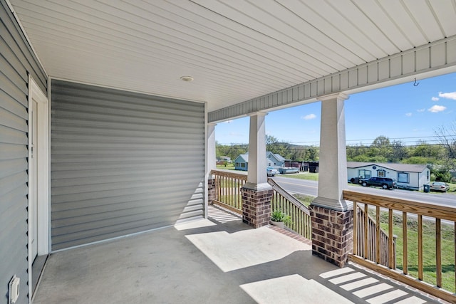view of patio featuring a porch and a residential view