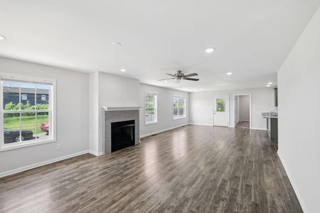 unfurnished living room featuring recessed lighting, dark wood-type flooring, a fireplace, and ceiling fan