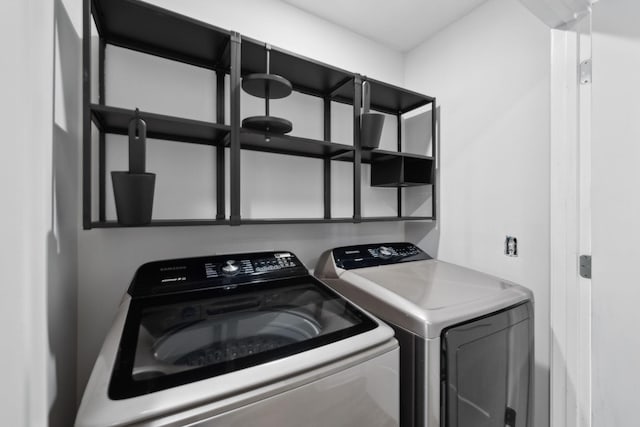 laundry area with separate washer and dryer and laundry area