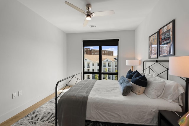 303 31st Ave N Unit 518, Nashville, TN 37203 - bedroom featuring wood finished floors, ceiling fan, baseboards, and visible vents