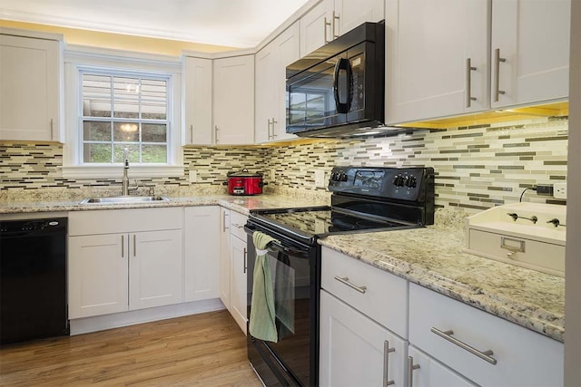 4712 Miners Cv, Antioch, TN 37013 - kitchen featuring white cabinets, a sink, black appliances, and decorative backsplash