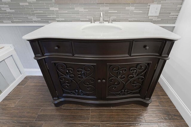 4712 Miners Cv, Antioch, TN 37013 - interior details with tasteful backsplash, baseboards, a sink, and wood finished floors