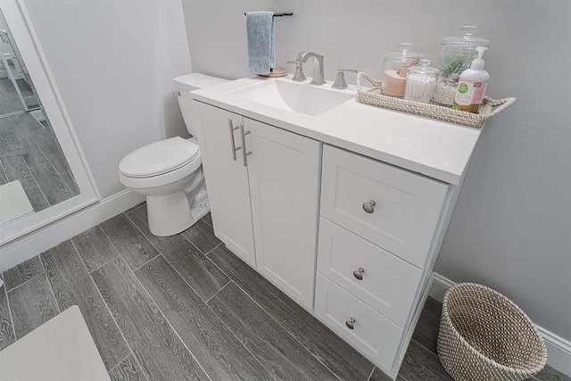 4712 Miners Cv, Antioch, TN 37013 - bathroom featuring vanity, baseboards, wood tiled floor, and toilet