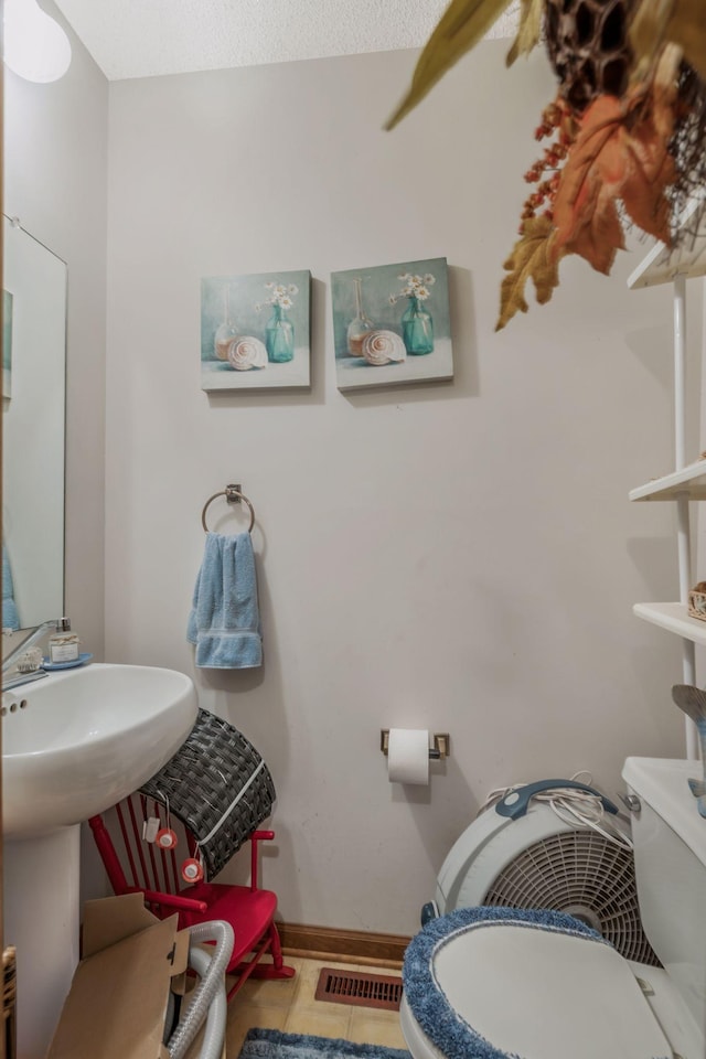 4801 Old Shelbyville Rd, Tullahoma, TN 37388 - half bath featuring baseboards, visible vents, tile patterned flooring, and toilet