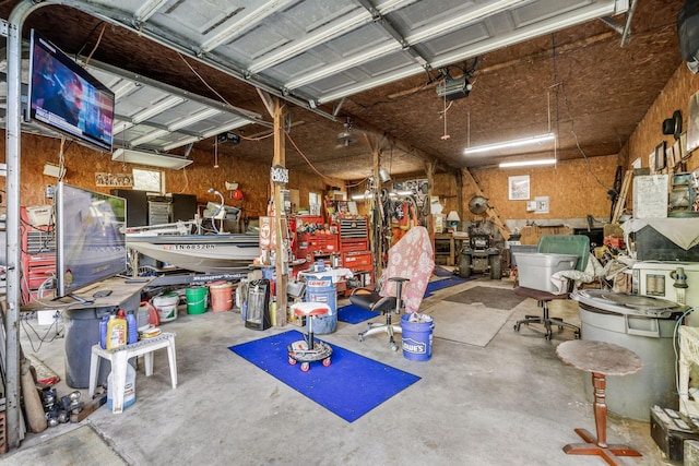 4801 Old Shelbyville Rd, Tullahoma, TN 37388 - garage featuring a workshop area and a garage door opener