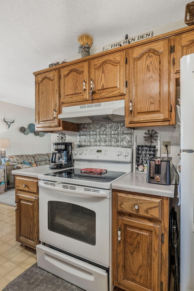 4801 Old Shelbyville Rd, Tullahoma, TN 37388 - kitchen with under cabinet range hood, white appliances, a textured ceiling, and brown cabinets