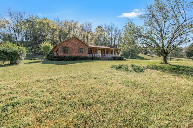4801 Old Shelbyville Rd, Tullahoma, TN 37388 - view of front of property featuring brick siding, a front yard, and covered porch