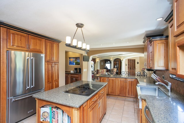 1035 Forest Harbor Dr, Hendersonville, TN 37075 - kitchen featuring brown cabinets, high end fridge, arched walkways, and black electric stovetop
