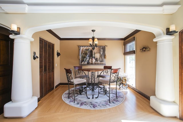 1035 Forest Harbor Dr, Hendersonville, TN 37075 - dining area with light wood-type flooring, an inviting chandelier, crown molding, decorative columns, and arched walkways