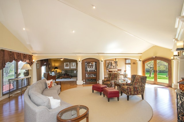 1035 Forest Harbor Dr, Hendersonville, TN 37075 - living area featuring arched walkways, decorative columns, lofted ceiling, and a wealth of natural light