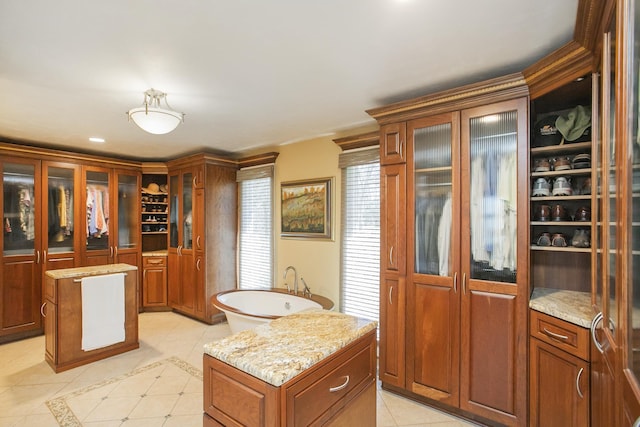 1035 Forest Harbor Dr, Hendersonville, TN 37075 - kitchen with light tile patterned floors, brown cabinetry, glass insert cabinets, and a kitchen island
