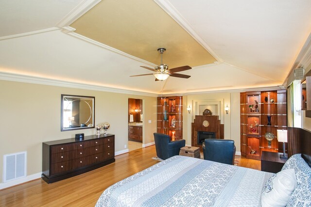 1035 Forest Harbor Dr, Hendersonville, TN 37075 - bedroom with a fireplace, ornamental molding, visible vents, wood finished floors, and lofted ceiling