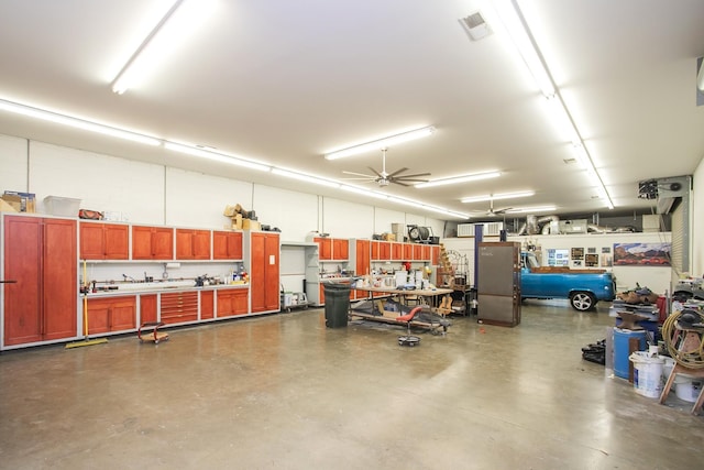 1035 Forest Harbor Dr, Hendersonville, TN 37075 - garage with visible vents, a ceiling fan, and a workshop area