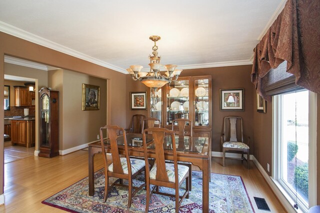 1035 Forest Harbor Dr, Hendersonville, TN 37075 - dining area with a chandelier, a wealth of natural light, light wood-style floors, and baseboards