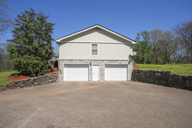 1035 Forest Harbor Dr, Hendersonville, TN 37075 - view of property exterior featuring concrete driveway, stone siding, and an attached garage