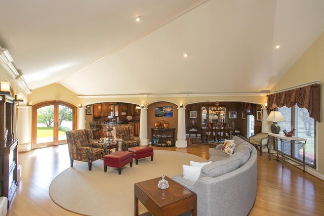 1035 Forest Harbor Dr, Hendersonville, TN 37075 - living area featuring a notable chandelier, light wood-style flooring, ornate columns, lofted ceiling, and arched walkways