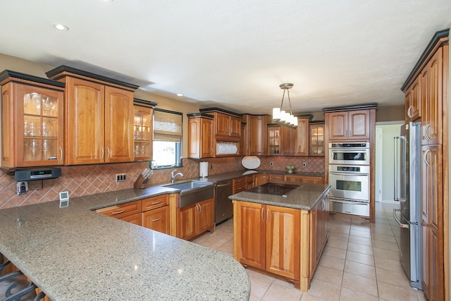 1035 Forest Harbor Dr, Hendersonville, TN 37075 - kitchen with a peninsula, a warming drawer, brown cabinets, appliances with stainless steel finishes, and a sink