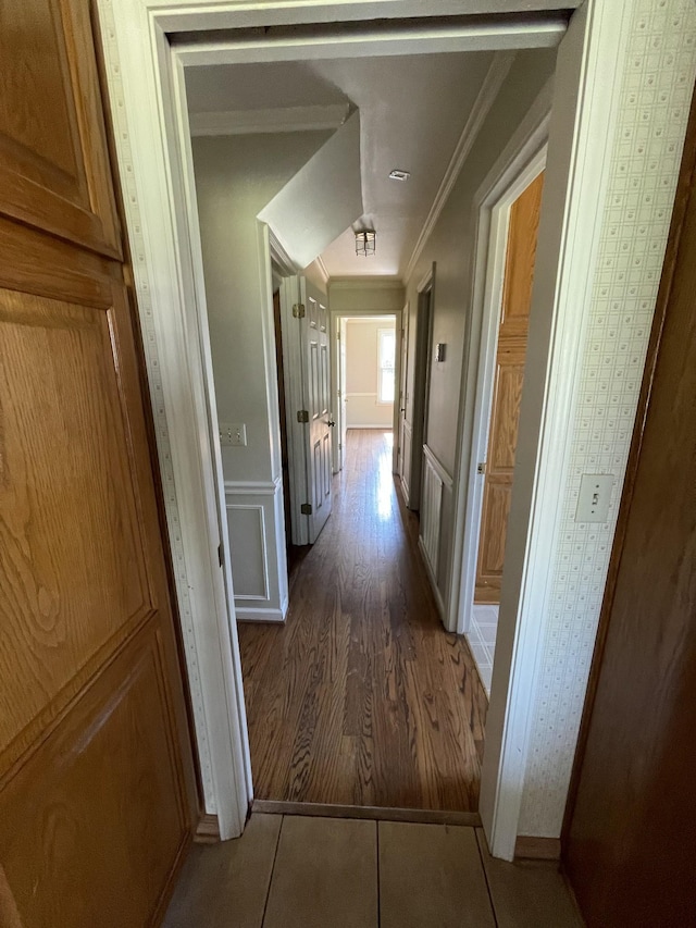 hallway with ornamental molding and tile patterned flooring