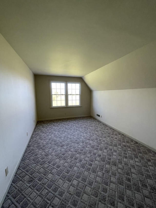 bonus room with visible vents, baseboards, carpet, and lofted ceiling