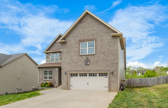 exterior space with a front lawn, driveway, fence, a garage, and brick siding
