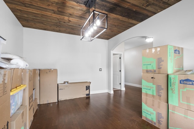interior space featuring wooden ceiling and baseboards