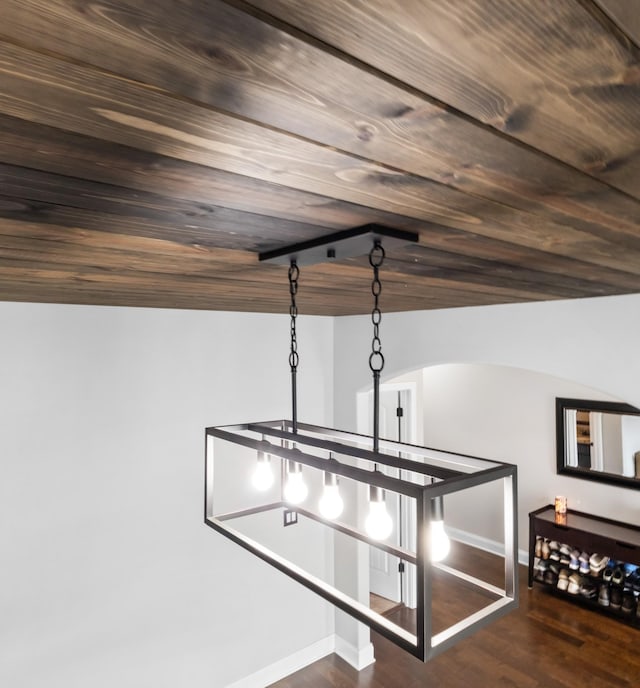 details featuring arched walkways, baseboards, wood ceiling, and wood finished floors