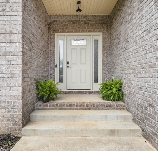property entrance with brick siding