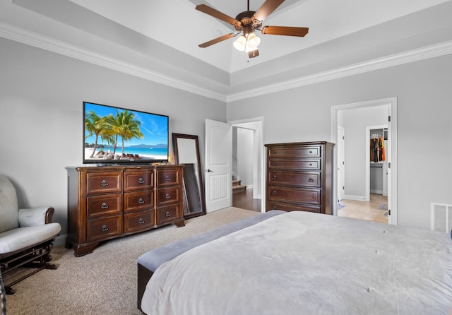 bedroom with baseboards, visible vents, ornamental molding, ceiling fan, and a raised ceiling