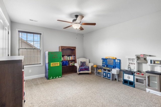 playroom with baseboards, a ceiling fan, visible vents, and carpet floors