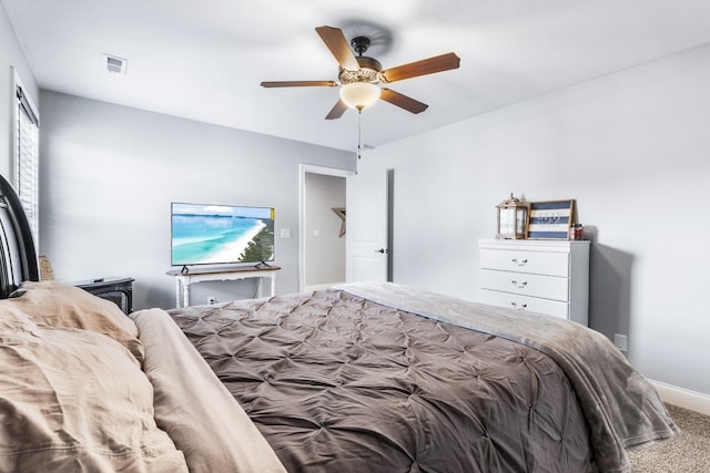 carpeted bedroom with baseboards, visible vents, and ceiling fan