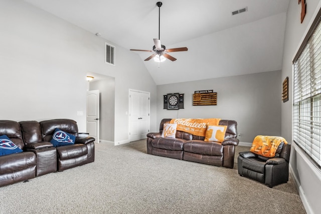 living area featuring carpet floors, visible vents, high vaulted ceiling, and a ceiling fan