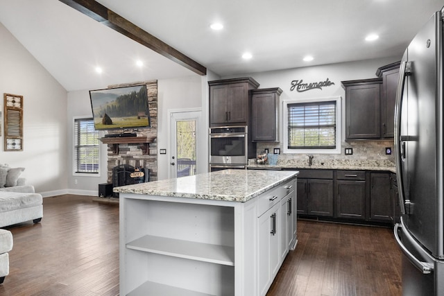 kitchen with open shelves, dark brown cabinetry, stainless steel appliances, dark wood-style flooring, and light stone countertops