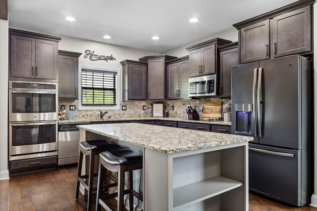kitchen featuring a center island, open shelves, dark brown cabinetry, stainless steel appliances, and backsplash