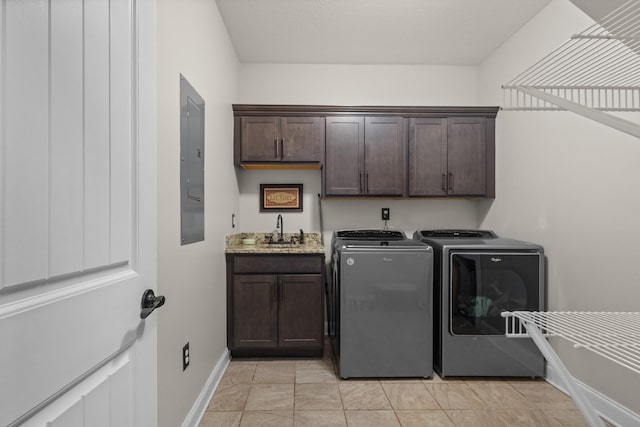 laundry room featuring a sink, separate washer and dryer, electric panel, cabinet space, and baseboards