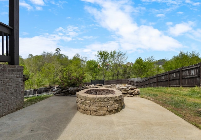 view of patio with a fenced backyard and a fire pit