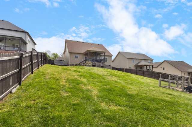 view of yard with a fenced backyard and stairs