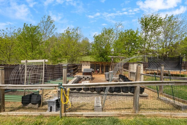 exterior space featuring a trampoline and fence