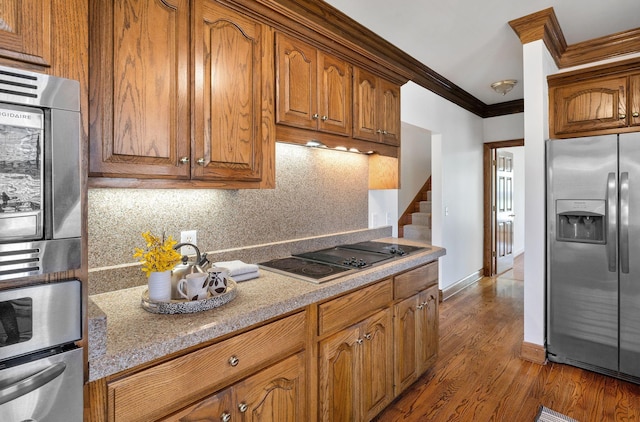 101 Christina Ct, Goodlettsville, TN 37072 - kitchen featuring tasteful backsplash, ornamental molding, appliances with stainless steel finishes, dark wood-style flooring, and brown cabinets