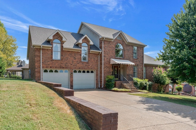 101 Christina Ct, Goodlettsville, TN 37072 - view of front of home with brick siding, driveway, a garage, and a front yard