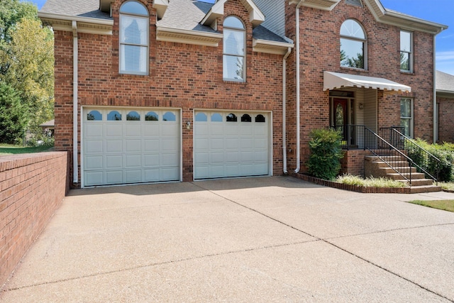 101 Christina Ct, Goodlettsville, TN 37072 - view of front of home with a shingled roof, brick siding, driveway, and an attached garage