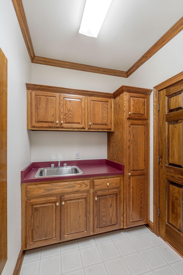 101 Christina Ct, Goodlettsville, TN 37072 - kitchen featuring a sink, brown cabinetry, light floors, and crown molding