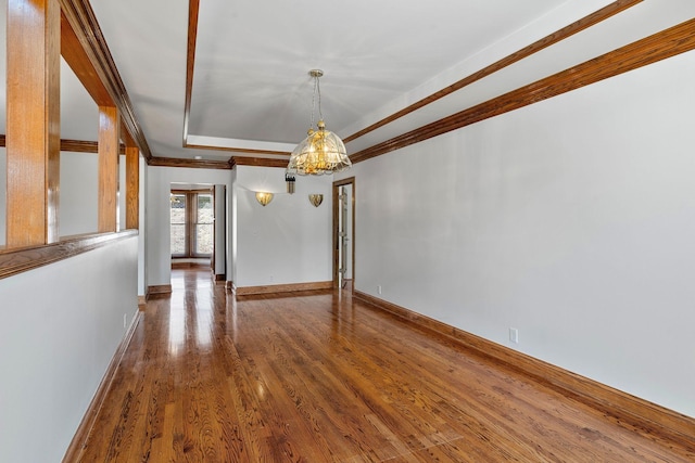 101 Christina Ct, Goodlettsville, TN 37072 - interior space with crown molding, a tray ceiling, wood finished floors, a notable chandelier, and baseboards