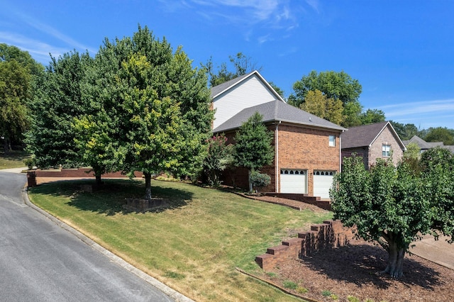 101 Christina Ct, Goodlettsville, TN 37072 - view of front of property with a shingled roof, brick siding, a front lawn, and an attached garage